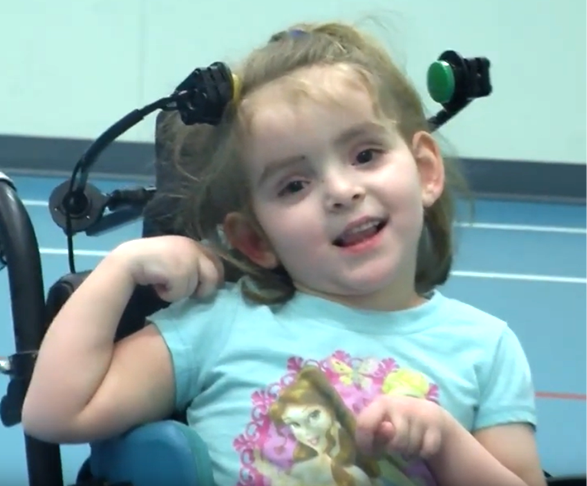 Child driving wheelchair utilizing two Spec switches activated via head movement 